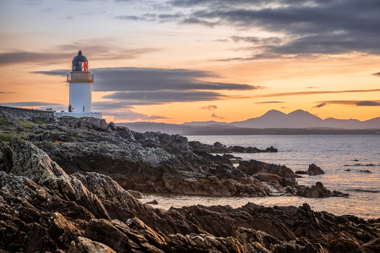 Scottish lighthouse on a rocky beach